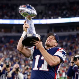 photograph of new england patriots qb mac jones lifting super bowl lombardi trophy, 5 0 mm lens