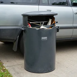unknown broken grill trash can 2003 vehicle on driveway, multifaceted, multitiered, various materials