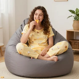 sitting in a beanbag chair in skimpy pajamas eating cheetos