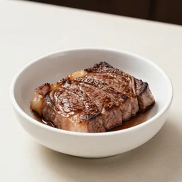 a bowl of steak on a table 3 / 4 th view
