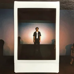 instax polaroid film photo of max headroom appearing on MTV 80s nostalgia, faded glow, expired film analog photography, grainy texturized dusty, saturated colorized