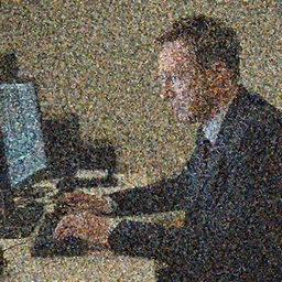cross between michael schumacher and hugh grant sits at a desk and stares at a screen with a concerned expression, optimal focal length