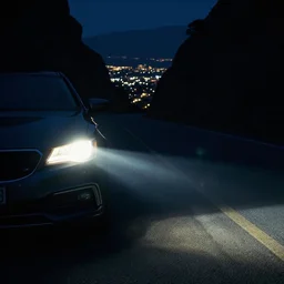 pov headlights of a car illuminate a strange dark canyon road, it's the dead of night, in a distance the bright city lights glow, cinematic, cinestill
