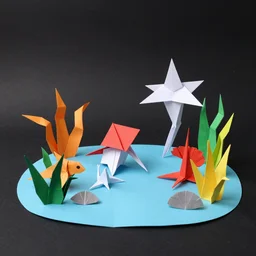 origami sea creatures in a paper ocean diorama