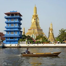 a man on a small boat on a river, ancient high blue buildings, yellow highly vertical classical temples, leica sl 2 3 5 mm, high quality, high detail