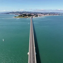 aerial footage of the new 50 km bridge in the middle of the Pacific Ocean between Wellington, North Island, and Blenheim, South Island, NZ, 8k panorama, grainy IMAX filter