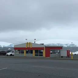 a photo of a small mcdonalds located in antarctica, realistic, poor quality