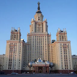 a wide shot of a soviet beautiful brutalist monumental multi - building industrial complex, tall buildings with spaceship parking lots on top, with many rounded elements sprouting from the base tower creating a feel of an organic structure, photography shot at blue hour