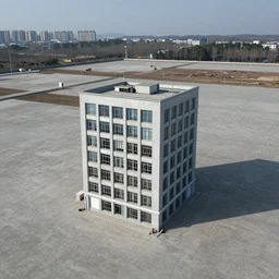 a building in the middle of a concrete field