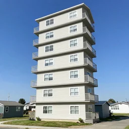 a column of stacked single wide mobile homes arranged 12 units high by Jim Burns and Craig Mullins