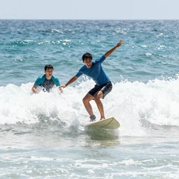 At our beach, at our magic beach, we swim in the sparkling sea, surfing and splashing and jumping the waves, shrieking and laughing with glee