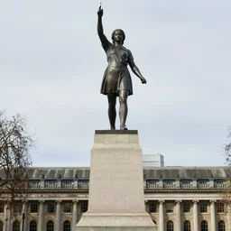 the statue of katniss everdeen stands atop a large plinth with london below