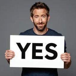 ryan reynolds holding a sign saying yes