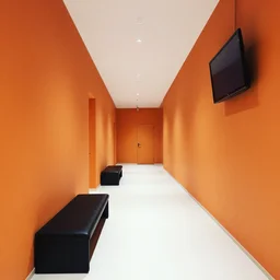 fancy corridor with orange walls and white floor. black benches. a tv hanging in the right upper corner.