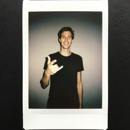 Polaroid photo of a tall thin pale man gesturing at the camera, tilting his head with an inhuman grin