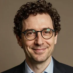 a man with glasses and dark short curly hair, smiling, style of maurice sendak
