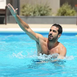 Alexandre Astier throwing Gad Elmaleh in a pool, photograph
