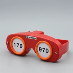 a 1 9 7 0 s product photo of an red / orange viewmaster vr headset manufactured by view master.