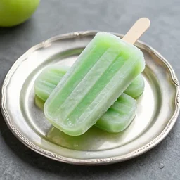 a green swedish popsicle served on a silver platter, professional photograph