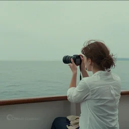 a woman taking a picture of herself on a boat, a screenshot by wes anderson, tumblr, symbolism, wide lens, photo, criterion collection
