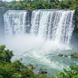 the most beautiful panoramic 3 5 mm photography where a giant dreamy waterfall creates a river the trees around are starting and a deer