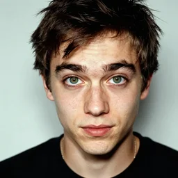 mischievous young man with grren eyes, candid portrait photograph by annie leibovitz