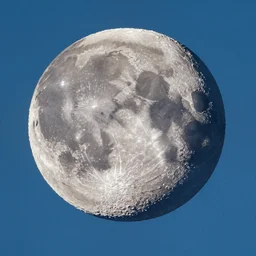 photo of the moon exploding in the sky on a clear, cloudless sky, blue sky