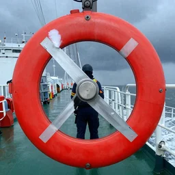 Inside the bridge of a ship in a severe storm, emergency