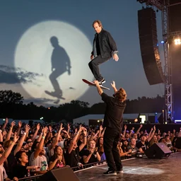 george costanza at the vans warped tour on stage, crowd surfing