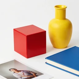red cude and yellow vase, blue book, photo