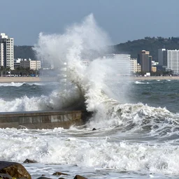 a world record tidal wave about to crash upon a coastal city