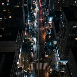 a city street at night, raining, photograph, cyberpunk, sharp focus, intricate detail, Desolate, drone shot,