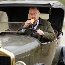 walter white eating cheese in an old 1900's automobile
