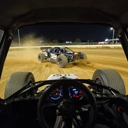 photo : first - person perspective view of interior of a banger racing car at the moment it smashes into a banger racing car on a dirt track at night, hdr, flash photography, fast shutter speed dslr