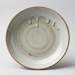 a large japanese handmade plate, drips, dripping glaze, glazed clay, crazed glaze glaze drips, artistic, exquisite, tea leaves, zen,