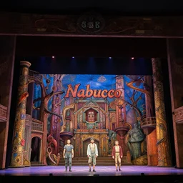 photo of a huge theaterstage, play is nabucco, 3 actors on stage, 8 k, multicolored, exaggerated detailed, long shot