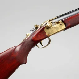 an antique double - barreled shotgun made from glossy red - painted wood and elements of gold metalwork