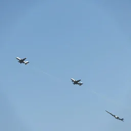a group of airplanes in the sky in formation.