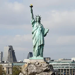 the statue of emma watson stands atop a large rock with london below