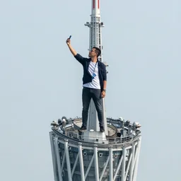 a man taking a selfie from the top of the tallest tower in the world, beautiful city, fish eye, wide lens