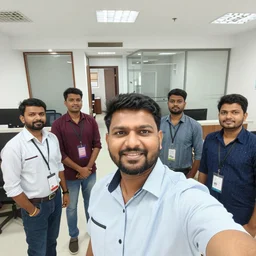 selfie taken by an Indian man with his other Indian employees at an office building, wide angle photo