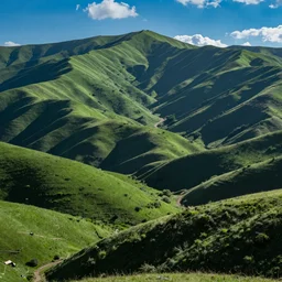 a beautiful photograph of green rolling mountains, blue sky, wide angle lens