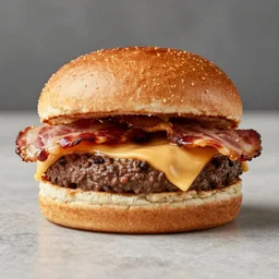 A photo of a juicy burger with bacon and cheese in a brioche bun no lettuce, zoomed in, 35mm