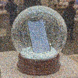A snowglobe is on display with a smartphone inside.