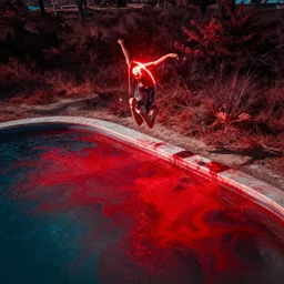 a guy jumping into a pool of red paint, digital art, 8 k, hdr, and harsh lighting. aerial photography. glowing paint, wild landscapes