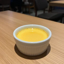 creme brulee on a light brown oak table in a night cafe, hyperrealistic, high detail, 8 k, award winning, professional photograph, liquor in the background, warm colors