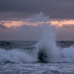 fibres of crashing waves spiral into the dusk sky
