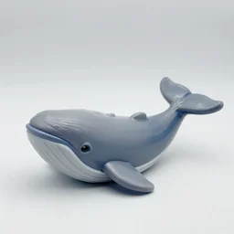 a plastic toy that looks like a whale. 8 0's. gray and blue