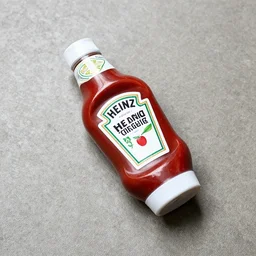 a heinz ketchup bottle lying on a cement floor