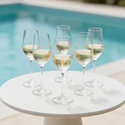 5 5 mm photo of glass of whitewineglass on a zen minimalist round white table with gorgeous pool in the background. highly detailed 8 k. intricate. lifelike. soft light,